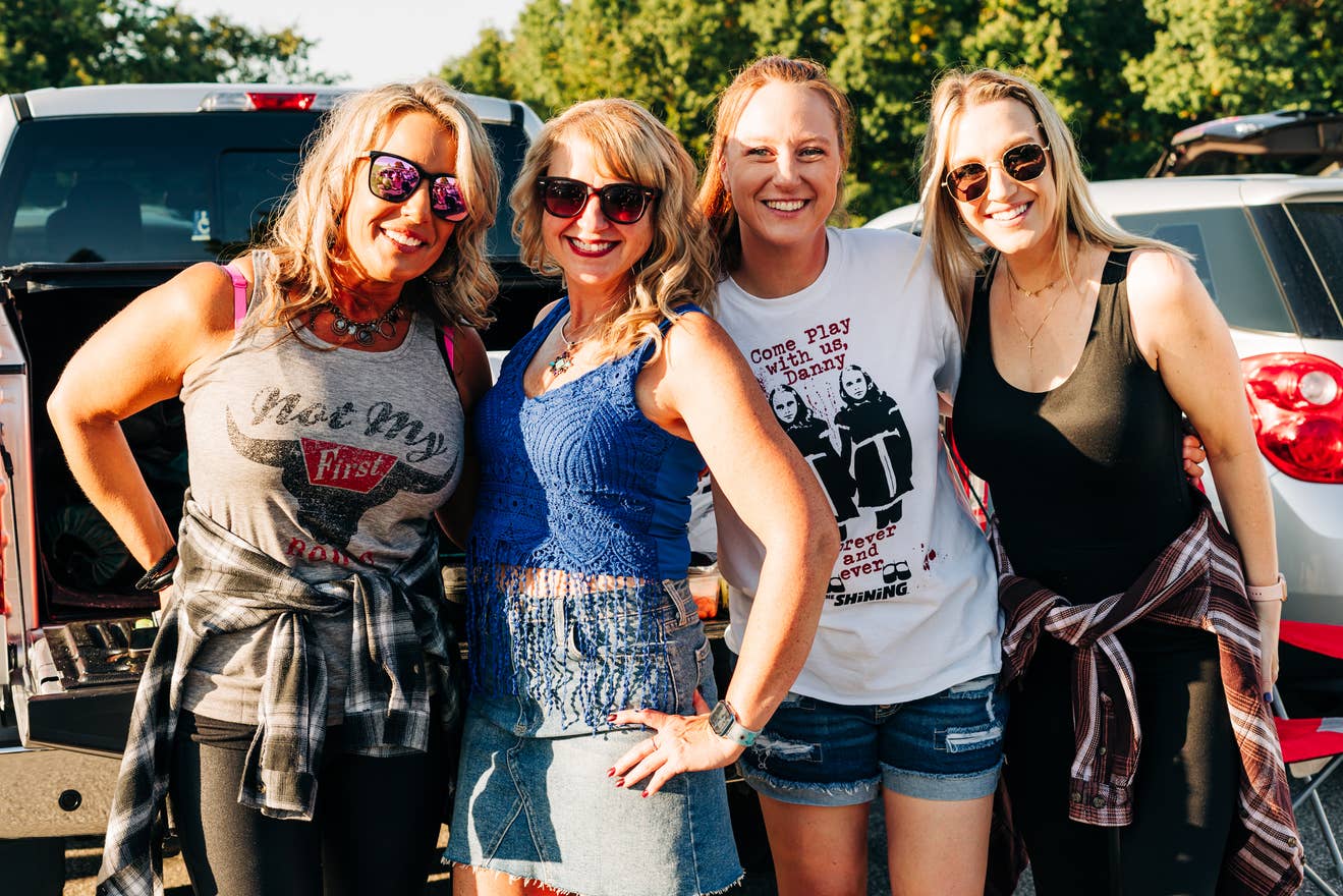 Group of fans gathered in a parking lot.